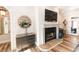 Bright living room featuring hardwood floors, a fireplace, and stylish decor at 3045 Camp Branch Rd, Buford, GA 30519