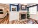Inviting living room with a stone fireplace, wood floors, and custom trim details at 3045 Camp Branch Rd, Buford, GA 30519