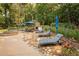 The outdoor patio with a pool, hot tub, fire place, lounge chairs and lush landscaping is perfect for relaxation and entertainment at 3045 Camp Branch Rd, Buford, GA 30519