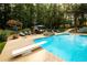 Swimming pool with diving board, hot tub, and outdoor eating area surrounded by lounge chairs at 3045 Camp Branch Rd, Buford, GA 30519