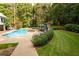 This outdoor living space boasts a pool, landscaped path, and an array of lounge chairs for relaxing poolside at 3045 Camp Branch Rd, Buford, GA 30519