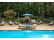 The swimming pool area features a stone hot tub with a waterfall, surrounded by comfortable lounge chairs and an outdoor dining area at 3045 Camp Branch Rd, Buford, GA 30519