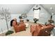 Sitting Room with comfortable leather chairs, soft neutral carpet, and decorative floral arrangements at 3045 Camp Branch Rd, Buford, GA 30519