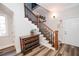 Staircase with hardwood steps, black painted spindles and beautiful wood flooring at 3045 Camp Branch Rd, Buford, GA 30519