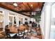 Bright sunroom with wooden ceiling, brick accents, dining area, and lots of natural light at 3045 Camp Branch Rd, Buford, GA 30519