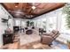Cozy sunroom featuring a wood plank ceiling, brick accents, and lots of natural light at 3045 Camp Branch Rd, Buford, GA 30519