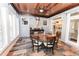 Charming sunroom with wood ceiling, lots of light, a round wooden dining table, and brick accents at 3045 Camp Branch Rd, Buford, GA 30519
