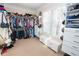 Bright walk-in closet featuring custom shelves, drawers, and plenty of space for storage at 3045 Camp Branch Rd, Buford, GA 30519