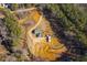 Aerial view of a charming home on a spacious lot surrounded by mature trees and natural landscape at 511 Monroe Cole Rd, Dallas, GA 30157