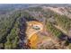 Stunning aerial view of a wooded property with long driveway leading to a home surrounded by lush greenery at 511 Monroe Cole Rd, Dallas, GA 30157