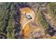 High angle view of property, showcasing home, outbuildings and winding driveway through a green tree lined estate at 511 Monroe Cole Rd, Dallas, GA 30157