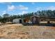 Barn and shed on a large lot with trees in the background on a sunny day at 511 Monroe Cole Rd, Dallas, GA 30157