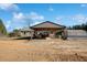 Barn and shed on a large lot with trees in the background on a sunny day at 511 Monroe Cole Rd, Dallas, GA 30157