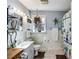 Bright bathroom features white tiled walls and a charming plant-themed shower curtain at 511 Monroe Cole Rd, Dallas, GA 30157