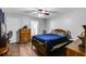 Comfortable bedroom featuring wood floors, a ceiling fan, dresser, and a blue comforter at 511 Monroe Cole Rd, Dallas, GA 30157