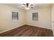 Bedroom featuring wood laminate flooring, a ceiling fan, and natural light from two windows at 511 Monroe Cole Rd, Dallas, GA 30157