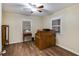 Bedroom featuring wood-look flooring, two windows, and wooden desk at 511 Monroe Cole Rd, Dallas, GA 30157