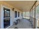 Covered porch featuring wood flooring, white railing, and a view of the wooded area at 511 Monroe Cole Rd, Dallas, GA 30157