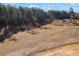 Picturesque property showcasing open land and a storage shed surrounded by a dense forest backdrop at 511 Monroe Cole Rd, Dallas, GA 30157