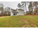 Exterior view of home features a lush lawn and mature trees at 146 Johns Blf, Auburn, GA 30011