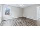 Bedroom featuring hardwood floors, a ceiling fan, and a large window at 146 Johns Blf, Auburn, GA 30011