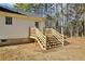 New wooden steps lead to a spacious, tree-lined backyard at 16 Vaughan Ne Dr, Cartersville, GA 30121