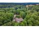 Aerial view of a home nestled among dense trees and lush greenery in a serene landscape at 955 Freehome Rd, Canton, GA 30115