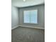 Cozy bedroom with plush carpeting, a window with blinds, and neutral-toned walls, for a comfortable retreat at 1685 Crumbley Rd, Mcdonough, GA 30252