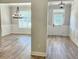 Elegant dining room featuring decorative wainscoting, modern lighting and views into other rooms at 1685 Crumbley Rd, Mcdonough, GA 30252