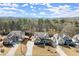 An aerial view shows three well-maintained houses in a wooded neighborhood at 170 Wheaten Dr, Woodstock, GA 30188