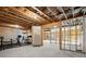 Unfinished basement with exposed rafters, stairs, a concrete floor, and an area for a home gym at 170 Wheaten Dr, Woodstock, GA 30188