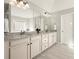 Bathroom featuring double sinks, granite countertops, and a large mirror at 170 Wheaten Dr, Woodstock, GA 30188