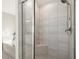Bathroom with a glass enclosed shower, a built-in bench seat, and a soaking tub in the background at 170 Wheaten Dr, Woodstock, GA 30188
