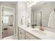 Bathroom with dual vanity, bright lighting, and doorway into bedroom at 170 Wheaten Dr, Woodstock, GA 30188