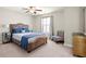 Bedroom featuring a plush bed, mirrored nightstands, and accent chair at 170 Wheaten Dr, Woodstock, GA 30188