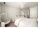Bedroom with hanging chair, chandelier, and ensuite bathroom doorway at 170 Wheaten Dr, Woodstock, GA 30188