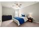 Bedroom with ceiling fan, ample natural light, and neutral color scheme at 170 Wheaten Dr, Woodstock, GA 30188