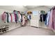 Large walk-in closet with wire shelving, carpeted floors, and a three-drawer chest at 170 Wheaten Dr, Woodstock, GA 30188