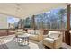 Covered deck with outdoor seating, ceiling fan, and scenic wooded views at 170 Wheaten Dr, Woodstock, GA 30188