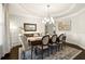 Elegant dining room featuring a chandelier, large area rug, and seating for eight at 170 Wheaten Dr, Woodstock, GA 30188