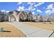 Long driveway leading to a beautiful home with a well-manicured lawn at 170 Wheaten Dr, Woodstock, GA 30188