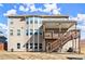 Exterior of house from the rear with multi-level deck, stairs, and ample windows at 170 Wheaten Dr, Woodstock, GA 30188