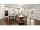 Bright kitchen with white cabinets, stainless steel appliances, granite countertops, and an eat-in breakfast nook at 170 Wheaten Dr, Woodstock, GA 30188