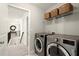 Upstairs laundry room featuring front load washer and dryer, baskets, and access to the hallway at 170 Wheaten Dr, Woodstock, GA 30188