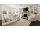 Cozy living room with a fireplace, built-in bookshelves, and comfortable seating at 170 Wheaten Dr, Woodstock, GA 30188