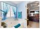 Serene bathroom with a soaking tub and scenic window views with blue accents at 1800 Rockdale Cir, Snellville, GA 30078