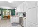 Efficient kitchen featuring white cabinets, stainless steel sink, and a breakfast nook at 1800 Rockdale Cir, Snellville, GA 30078