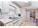 Kitchenette sink and cabinet space with window, view into a bonus area and additional cabinets at 1800 Rockdale Cir, Snellville, GA 30078