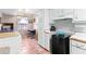 White kitchenette cabinets with tile floor, window and mini-refrigerator at 1800 Rockdale Cir, Snellville, GA 30078