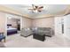 Neutral carpet living room, ceiling fan, with partial view into another bedroom at 1800 Rockdale Cir, Snellville, GA 30078